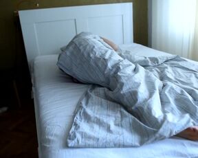 Girl's bare feet in bed