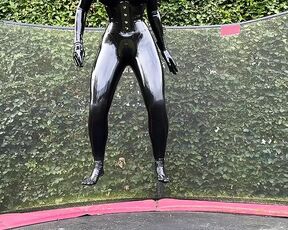 Miss Fetilicious jumping in latex catsuit