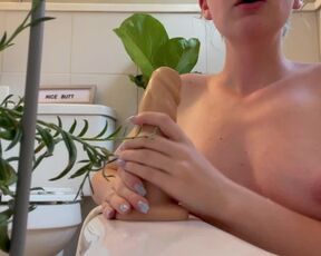 Sage gives a sloppy blowjob to a 8” dildo in the tub