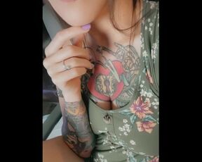 Tattooed girl in dress teases