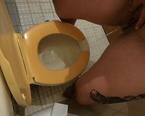 She is pissing standing to the toilet