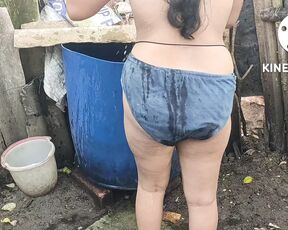 Hot indian house wife bathing outside and washing clothes